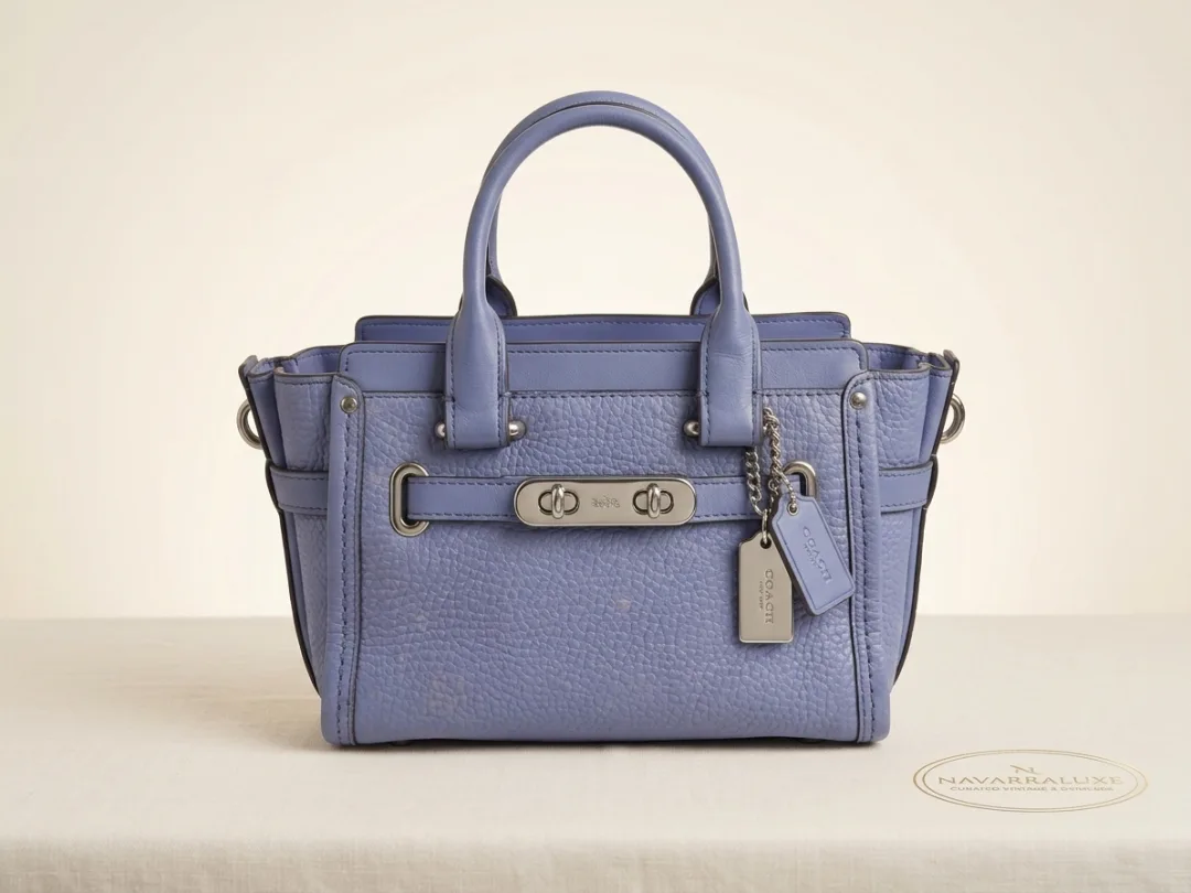 Authentic Coach Swagger 20 in periwinkle blue pebbled leather with silver turn-lock and hangtags.