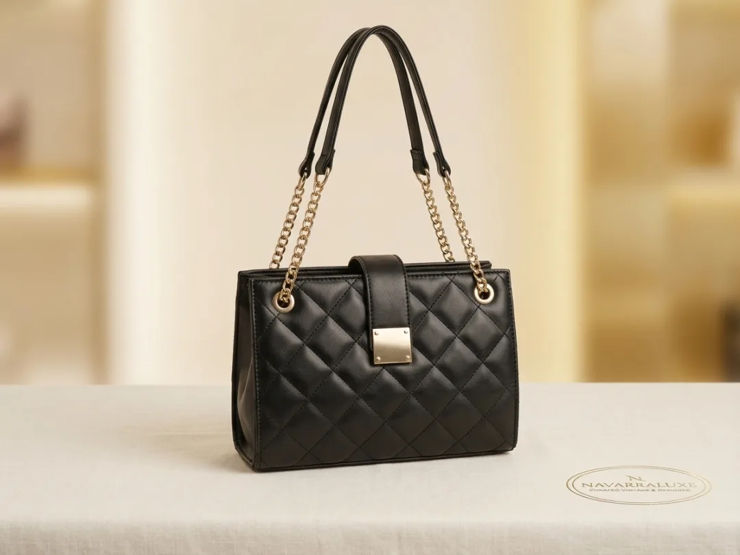Black diamond-quilted shoulder bag with gold chain straps and a gold plaque turn-lock.